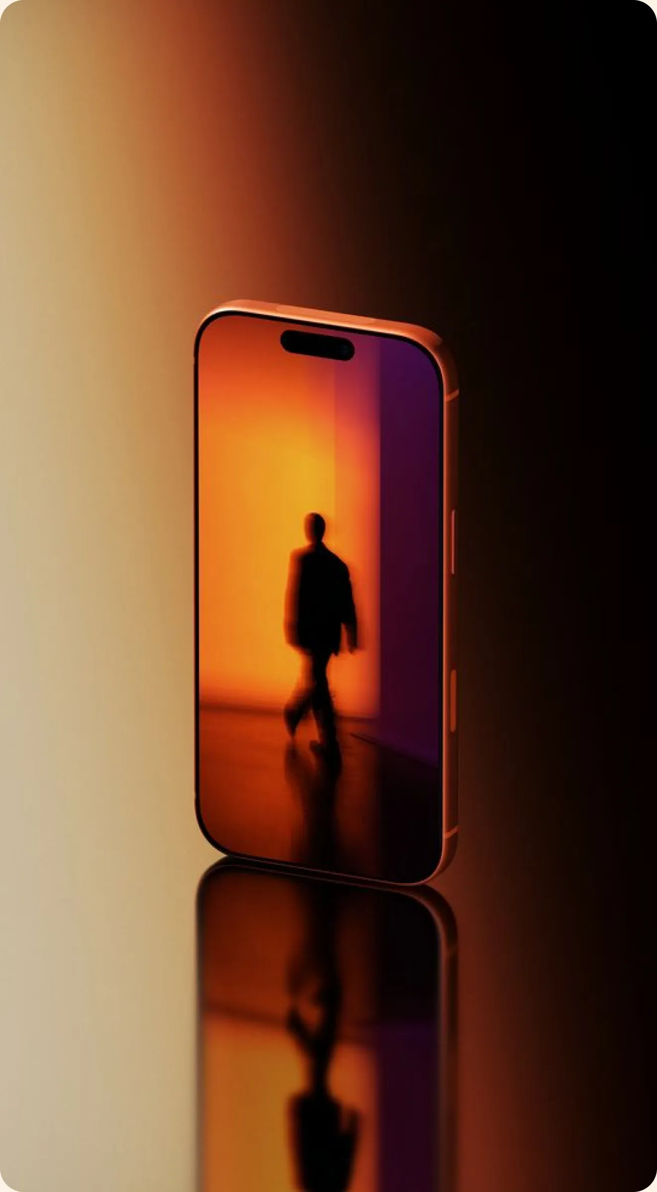 Smartphone on a reflective surface showing a silhouette in orange light