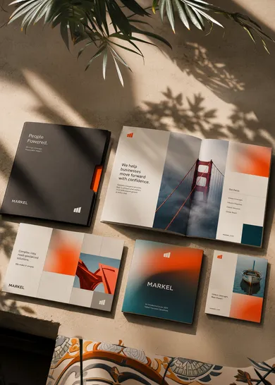 Flat lay of printed brochures and brand collateral