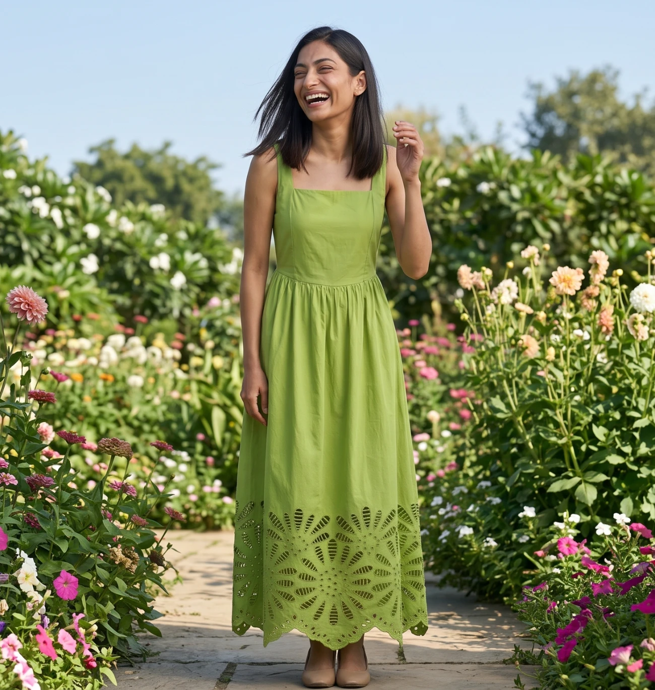 Model wearing a green eyelet dress, shown full length